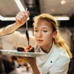 Chef plating a gourmet dish.