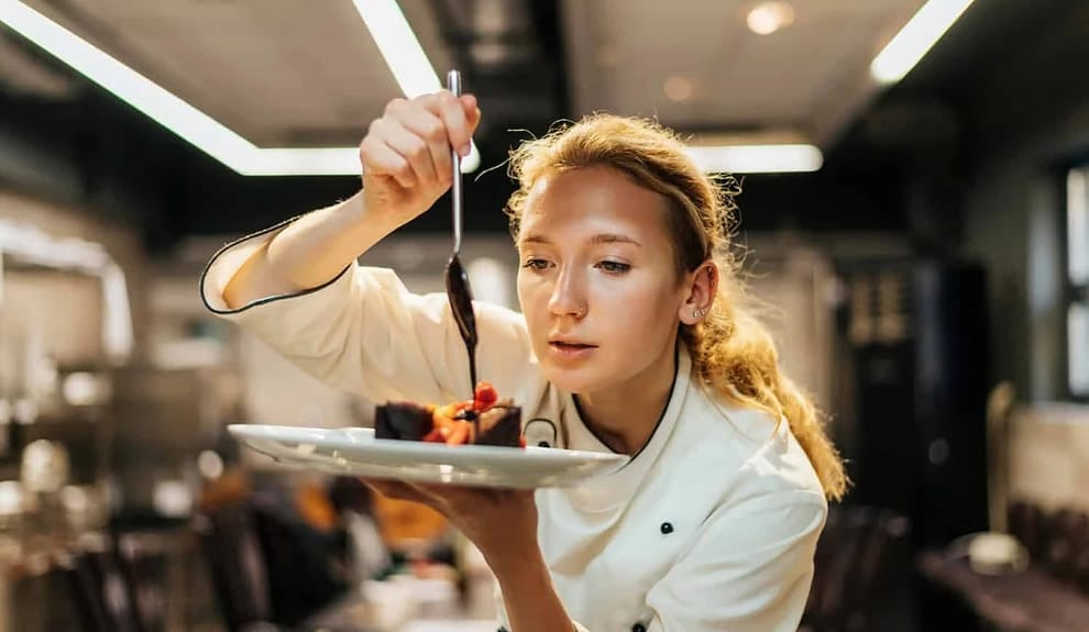 Chef plating a gourmet dish.