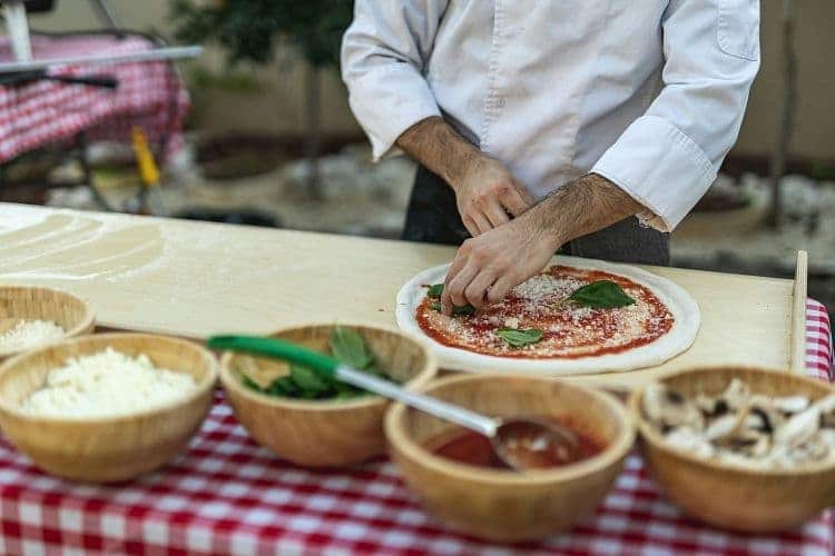 chef cooking salmon pizza